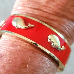 Bright orange bracelet with gold whales